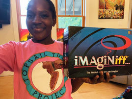 Young kid with box that says imaginiff