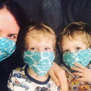 photo of Sharon Shewmake and two sons wearing facemasks