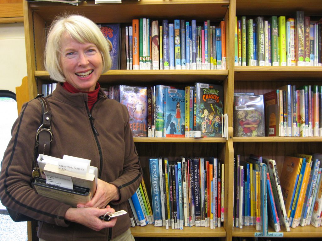 Photo of woman holding books
