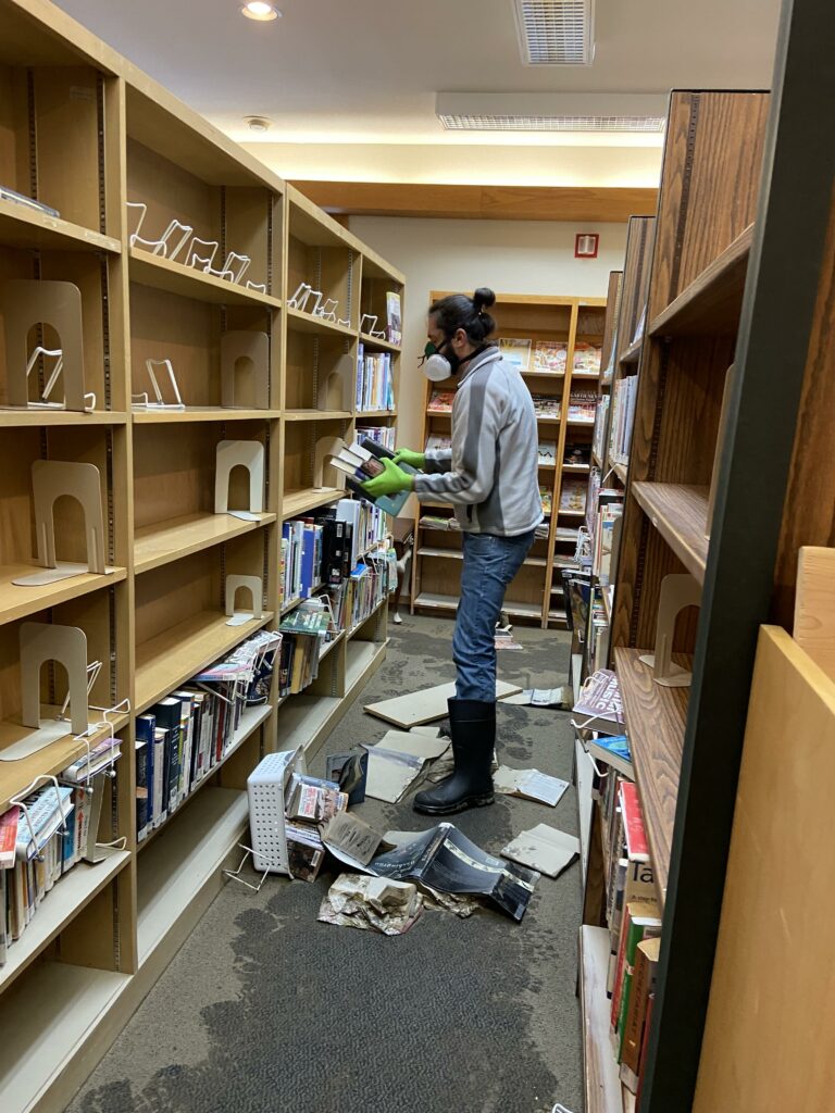 WCLS Deputy Director Michael Cox salvaging books from the Sumas Library after the November 2021 flood
