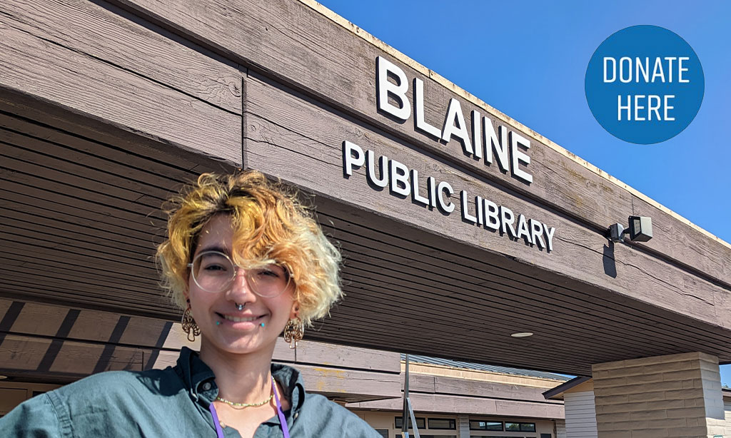 Blaine Library sign with staff member in foreground