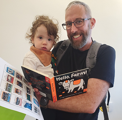 Toddler and father with book