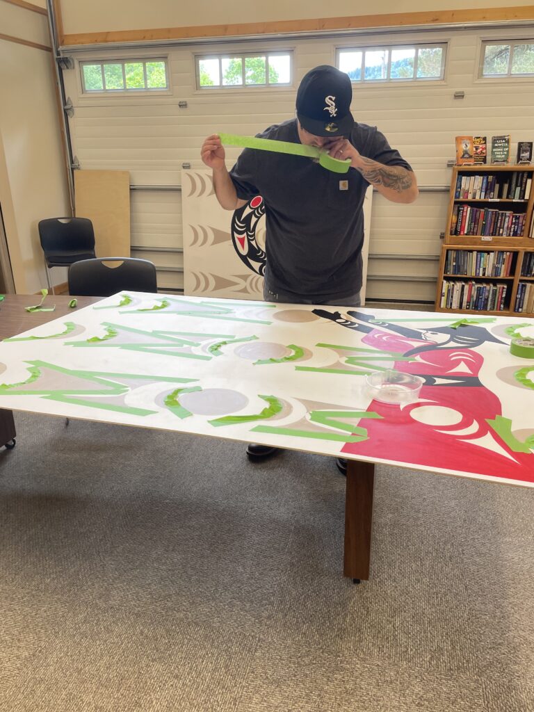 Jason LaClair working on mural