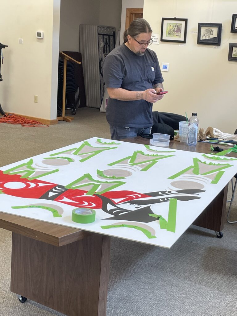 Jason LaClair working on mural