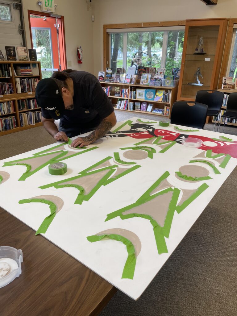 Jason LaClair working on mural