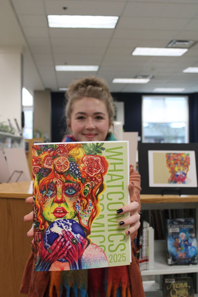 Artist holding Whatcomics publication