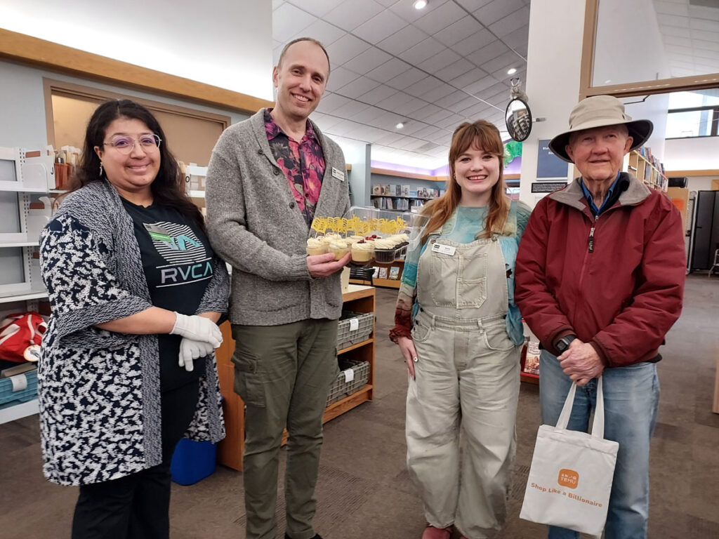 Three Blaine Library staff standing with patron in the library