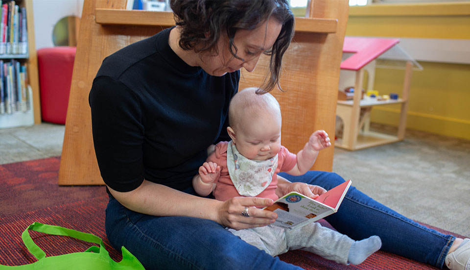 Mother reading to her baby