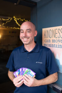 Man holding library game cards
