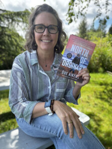woman holding book by Sue Aiken