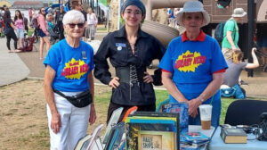 Two Friends of the Blaine Library and a library staff member standing at a park